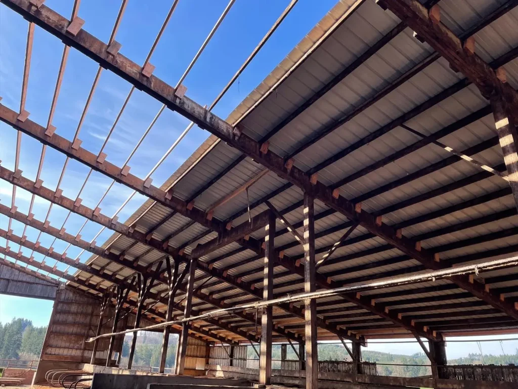 Large pole barn interior with exposed roof framing and support beams
