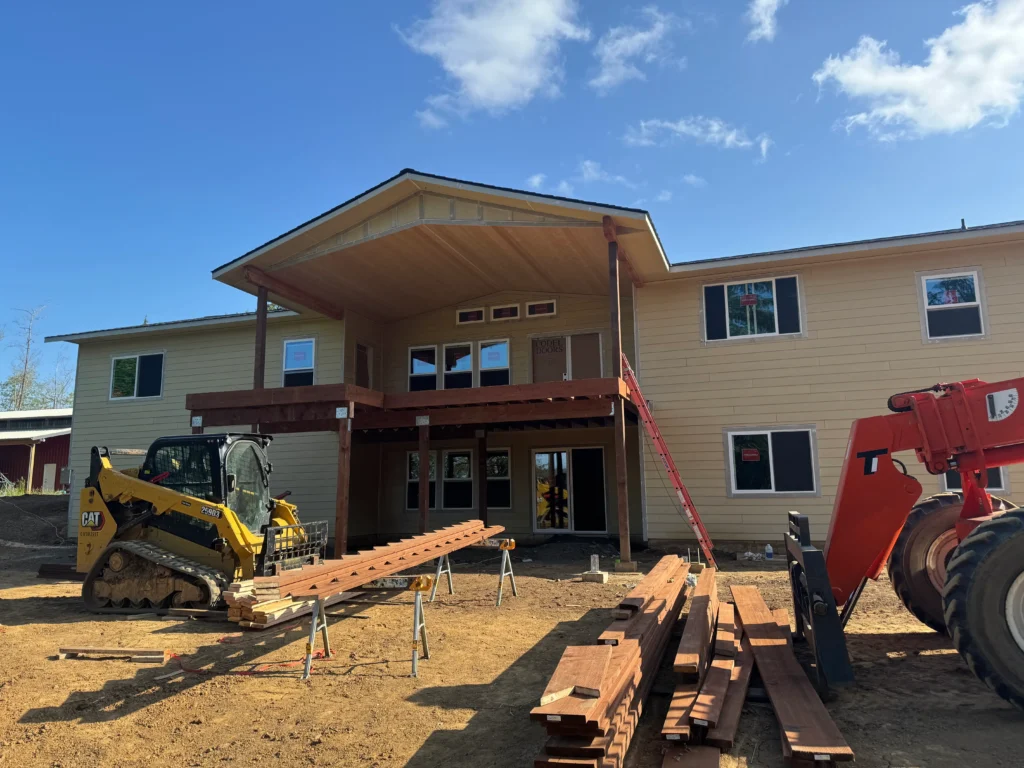 Residential home under construction with framing and exterior work in progress